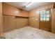 Small room featuring paneled walls, pegboard, shelf and door to the backyard at 741 Greenhill Ne Dr, Conyers, GA 30012