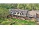 Aerial view of brick home featuring manicured grounds at 115 Shoal Creek Dr, Sharpsburg, GA 30277