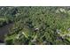 Aerial view highlighting the property's location among dense trees and a nearby lake, emphasizing privacy and nature at 115 Shoal Creek Dr, Sharpsburg, GA 30277