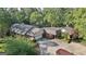 Aerial view of the sprawling estate with mature trees and landscaping at 115 Shoal Creek Dr, Sharpsburg, GA 30277