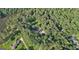Home and manicured lawns surrounded by dense forest, as seen from an aerial view at 115 Shoal Creek Dr, Sharpsburg, GA 30277