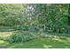 Picturesque backyard garden with a charming swing and vibrant hydrangeas, creating a serene and inviting outdoor space at 115 Shoal Creek Dr, Sharpsburg, GA 30277