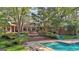 Gorgeous backyard features a sparkling pool, multi-tiered patio, and lush landscaping, perfect for entertaining at 115 Shoal Creek Dr, Sharpsburg, GA 30277