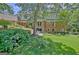 Expansive brick home with well-maintained lawn, garden and trees, creating a tranquil backyard retreat at 115 Shoal Creek Dr, Sharpsburg, GA 30277