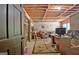 This basement features a large desk, brick fireplace, and exposed wooden rafters, offering a unique space at 115 Shoal Creek Dr, Sharpsburg, GA 30277
