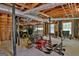 Unfinished basement with exposed ceiling, lawn equipment, and potential for customization at 115 Shoal Creek Dr, Sharpsburg, GA 30277