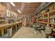 Spacious basement workshop area with pegboard storage, shelving, and workbenches for various projects at 115 Shoal Creek Dr, Sharpsburg, GA 30277