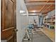 Unfinished basement area with visible ceiling beams and exercise equipment, offering potential for customization at 115 Shoal Creek Dr, Sharpsburg, GA 30277