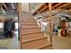 Basement stairs leading down to storage and mechanical equipment with exposed ductwork at 115 Shoal Creek Dr, Sharpsburg, GA 30277