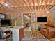 Basement office space with a work desk, leather chair, and an exposed wood ceiling at 115 Shoal Creek Dr, Sharpsburg, GA 30277