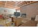 Unfinished basement with desk area, fireplace and exposed ceiling at 115 Shoal Creek Dr, Sharpsburg, GA 30277