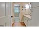 Bathroom showcasing a granite vanity, wooden floors, and open doorway to the toilet at 115 Shoal Creek Dr, Sharpsburg, GA 30277