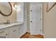 Bathroom with a granite countertop vanity, a sink, and a white door at 115 Shoal Creek Dr, Sharpsburg, GA 30277