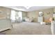 Spacious bedroom featuring neutral carpeting, large window, and charming decor at 115 Shoal Creek Dr, Sharpsburg, GA 30277