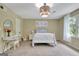 Bright, spacious bedroom with carpet, a bed, a vanity, and natural light streaming through the large windows at 115 Shoal Creek Dr, Sharpsburg, GA 30277