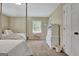 Bright bedroom with carpeted floors featuring two stylish beds, and a window that fills the space with natural light at 115 Shoal Creek Dr, Sharpsburg, GA 30277