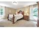 Bedroom features a traditional bed frame, two windows and neutral carpeting at 115 Shoal Creek Dr, Sharpsburg, GA 30277