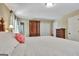 Bedroom featuring a full closet, warm lighting, and neutral carpeting at 115 Shoal Creek Dr, Sharpsburg, GA 30277