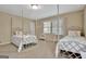 Inviting bedroom with carpet, twin beds, large window and neutral decor, offering a comfortable and stylish living space at 115 Shoal Creek Dr, Sharpsburg, GA 30277