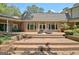 Inviting brick patio offers a cozy outdoor retreat with comfortable seating and lush surroundings at 115 Shoal Creek Dr, Sharpsburg, GA 30277