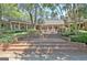 Multi-tiered brick patio offers ample space for outdoor seating and entertaining in a private backyard setting at 115 Shoal Creek Dr, Sharpsburg, GA 30277