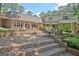 Spacious brick patio with multiple seating areas provides a perfect spot for outdoor relaxation and gatherings at 115 Shoal Creek Dr, Sharpsburg, GA 30277