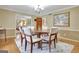 Open dining room with a round table and natural light at 115 Shoal Creek Dr, Sharpsburg, GA 30277