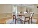 Traditional dining room with wood table, chair set, area rug, and view to living area at 115 Shoal Creek Dr, Sharpsburg, GA 30277