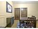 Inviting dining space with framed memorabilia, dark wood furniture, and ample natural light at 115 Shoal Creek Dr, Sharpsburg, GA 30277