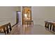A partial view of a wooden table with a glimpse into the neighboring bathroom at 115 Shoal Creek Dr, Sharpsburg, GA 30277