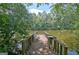 Relaxing dock with seating overlooking the calm pond, ideal for unwinding and enjoying the natural surroundings at 115 Shoal Creek Dr, Sharpsburg, GA 30277