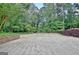 Spacious driveway with lush landscaping at 115 Shoal Creek Dr, Sharpsburg, GA 30277