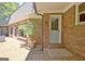 Charming brick entryway with accent door and manicured yard and plantings, offering a welcoming first impression at 115 Shoal Creek Dr, Sharpsburg, GA 30277