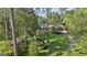 Charming brick home with a manicured lawn, a curved driveway, and mature trees for privacy at 115 Shoal Creek Dr, Sharpsburg, GA 30277