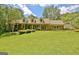 A lovely brick home with dormer windows and a well-kept lawn creates a warm, inviting curb appeal at 115 Shoal Creek Dr, Sharpsburg, GA 30277