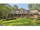 Charming brick home featuring dormer windows and a well-manicured front lawn at 115 Shoal Creek Dr, Sharpsburg, GA 30277