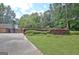 Well-maintained property with landscaping and a circular driveway at 115 Shoal Creek Dr, Sharpsburg, GA 30277