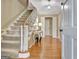 Welcoming foyer with hardwood floors, staircase, and elegant decor at 115 Shoal Creek Dr, Sharpsburg, GA 30277