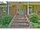 Inviting brick porch with brick steps and a light blue front door at 115 Shoal Creek Dr, Sharpsburg, GA 30277