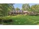 Charming brick home with a well-manicured lawn and mature trees creating a picturesque setting at 115 Shoal Creek Dr, Sharpsburg, GA 30277