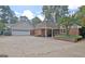 Brick and siding home with an attached two-car garage and a circular driveway at 115 Shoal Creek Dr, Sharpsburg, GA 30277