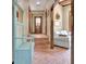 Hallway with brick steps, coat rack, paneled doors, and access to living area at 115 Shoal Creek Dr, Sharpsburg, GA 30277
