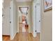 Hallway features hardwood flooring and access to kitchen, living room, and bedrooms at 115 Shoal Creek Dr, Sharpsburg, GA 30277