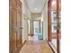 Hallway features brick flooring, wood paneled doors, and access to the kitchen at 115 Shoal Creek Dr, Sharpsburg, GA 30277