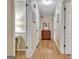 Inviting hallway featuring hardwood floors and neutral walls that add warmth and character to the home at 115 Shoal Creek Dr, Sharpsburg, GA 30277