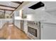 A modern kitchen boasting white cabinets, stainless steel appliances, and sleek countertops at 115 Shoal Creek Dr, Sharpsburg, GA 30277