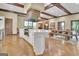 Open kitchen with a large island, white countertops, and wooden beam ceiling at 115 Shoal Creek Dr, Sharpsburg, GA 30277