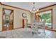Bright eat-in kitchen with tiled floor, dark wood trim, large windows, and charming decor at 115 Shoal Creek Dr, Sharpsburg, GA 30277