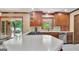 Kitchen with white countertop, stainless steel appliances, custom cabinets, and backyard view at 115 Shoal Creek Dr, Sharpsburg, GA 30277