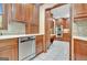 Bright kitchen with built in stainless oven and microwave, tile floor, and custom cabinets at 115 Shoal Creek Dr, Sharpsburg, GA 30277